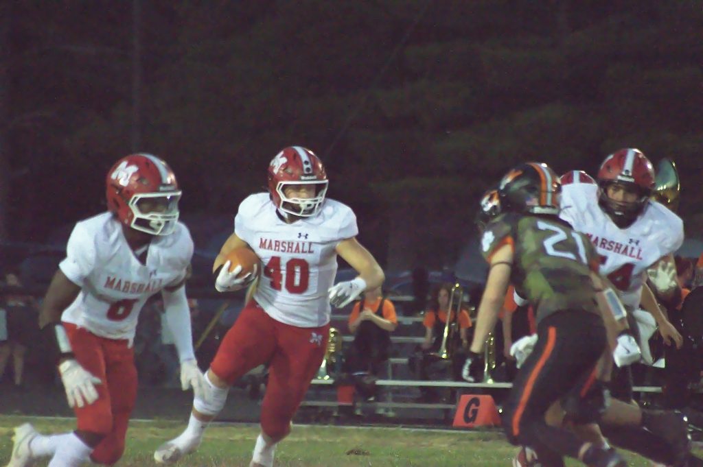 Lucca Giannavola (40) turns the corner and gains yardage against Olney. Photo by T Ray Henry. 