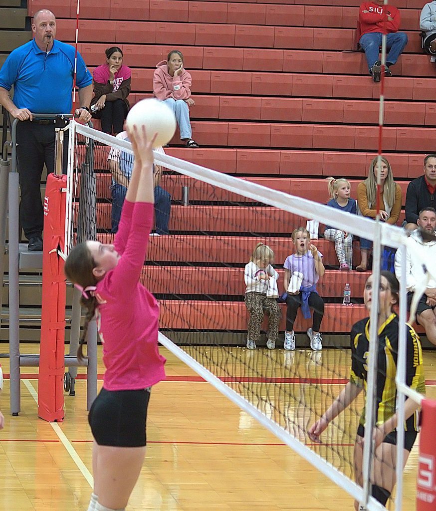 Addy Ross gets the block at the net. Photo by T Ray Henry.