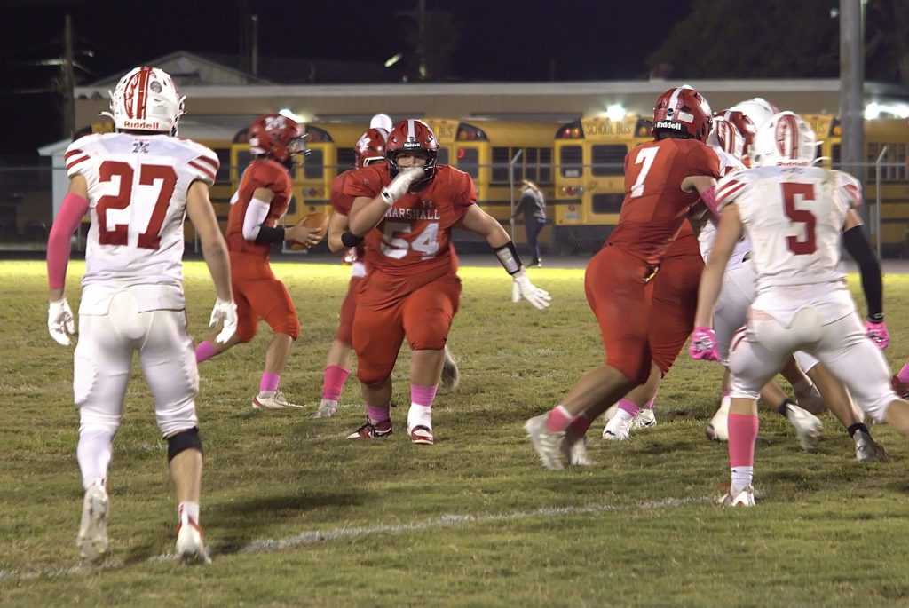 Boston Rollings (54) leads the way around the edge for Marshall against Lawrenceville