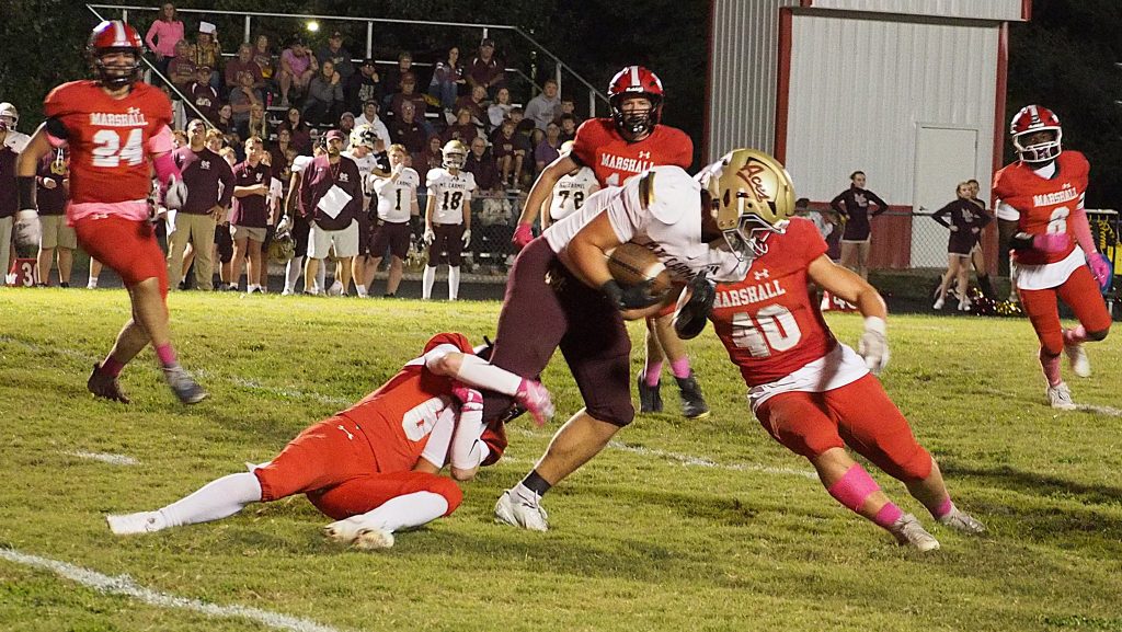 Silas Dean (6) and Lucca Giannavola (40) combine to bring the Mount Carmel ball carrier to the ground
